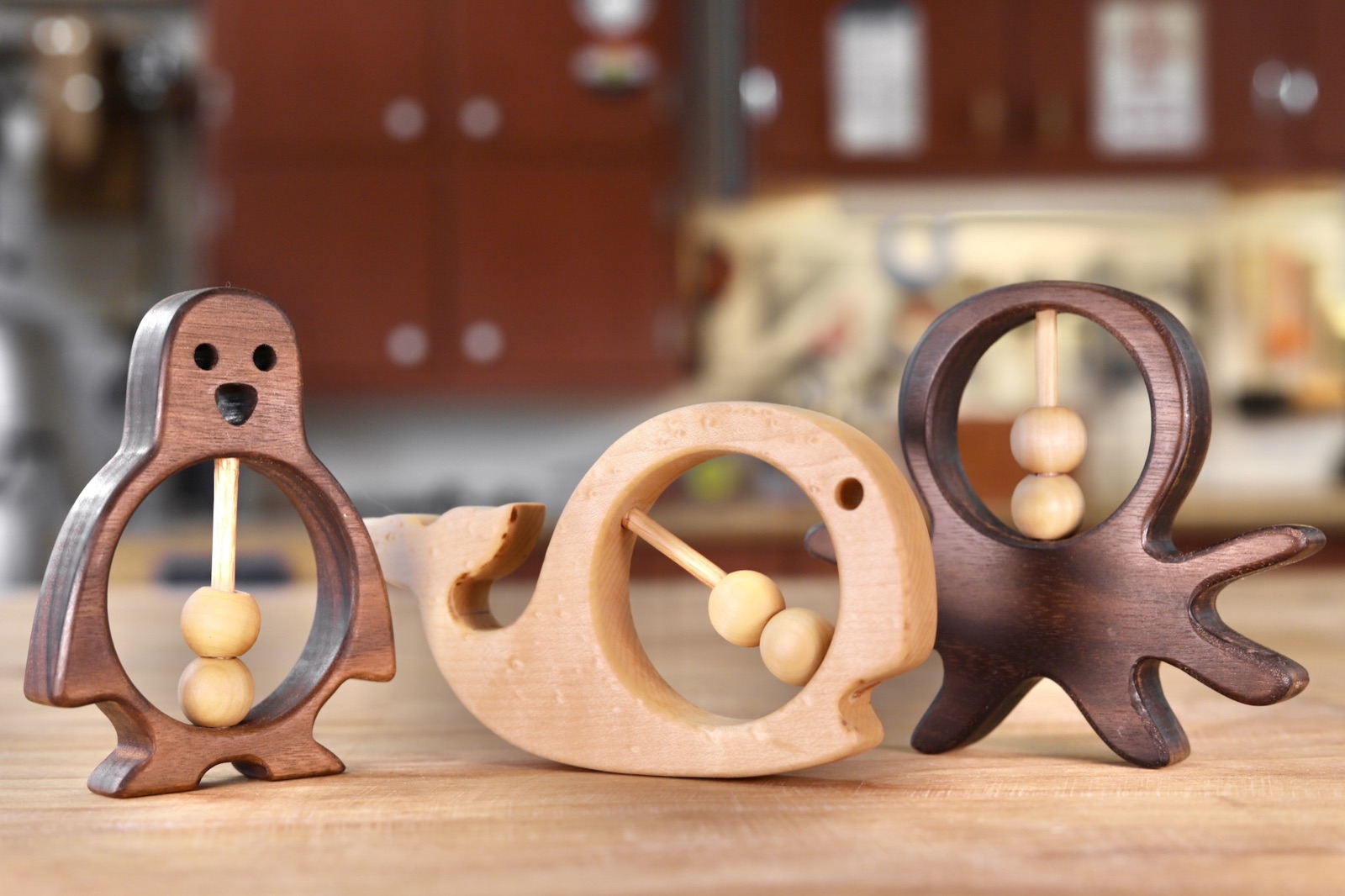 A family of wooden ocean-animal rattles