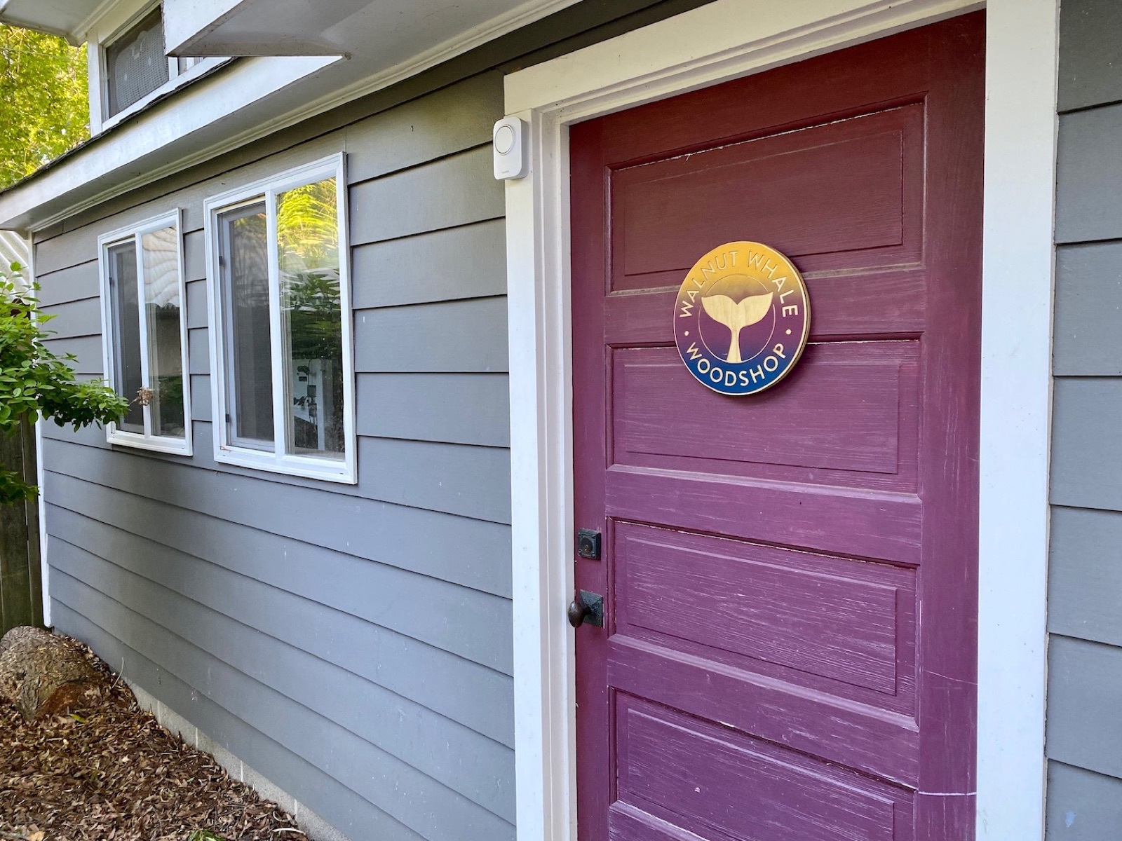 The Walnut Whale Woodshop with its whale sign on the door